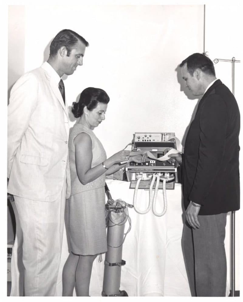 Dr. Nanette Wenger in the 1960s checking research data with her trainees, Dr. William Walters (left) and Dr. Charles Harrison. (Emory Medicine Magazine, Fall 2008)